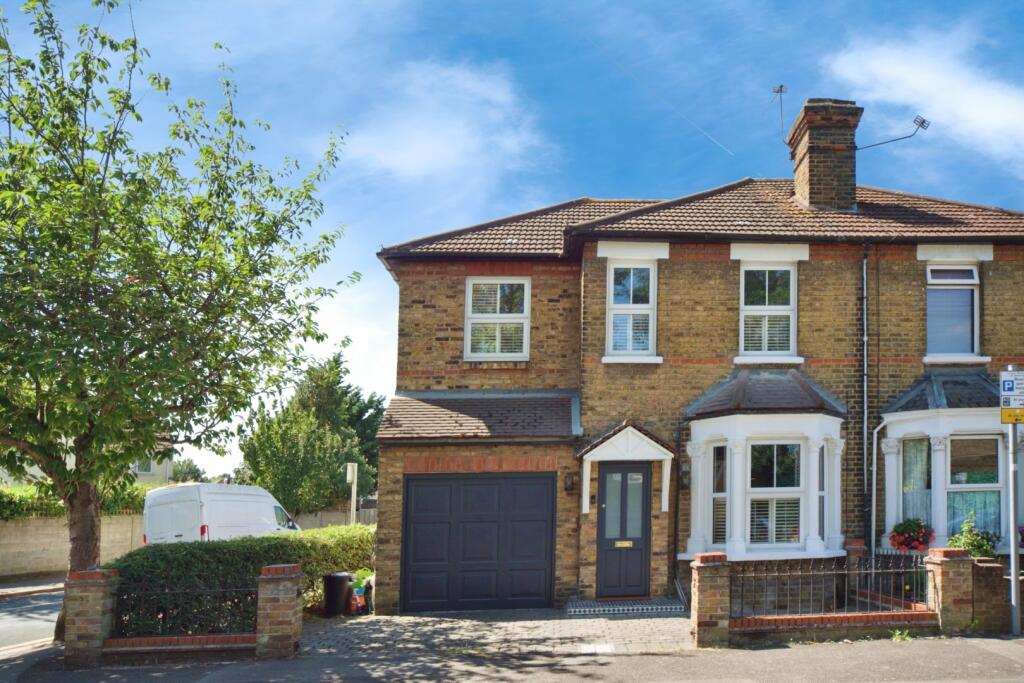 A semi-detached house on Cotleigh Road extended to the side, with an integral garage beneath a two-storey addition alongside the original bay-fronted elevation
